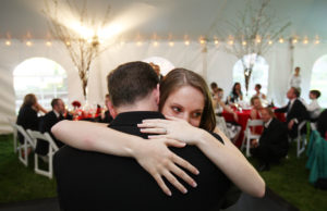 Bride hugs her father during her wedding reception in Annandale, Virginia
