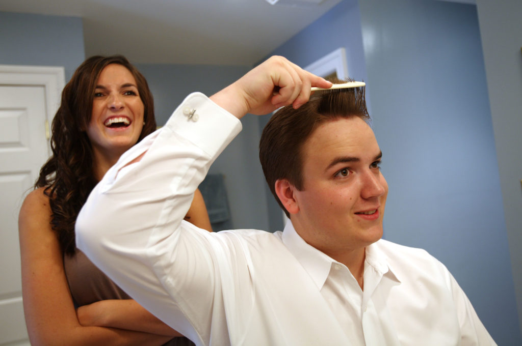 Groom getting ready for his wedding ceremony with the help of the maid of honor in Annandale, Virginia
