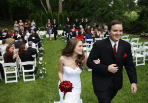 Husband and wife leave their backyard wedding ceremony in Annandale, Virginia.